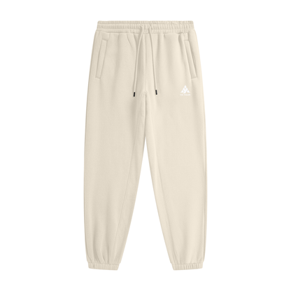 YA TOUR Unisex Heavyweight Fleece Joggers – Cream Apricot, front flat lay showing mid-rise elastic waistband with drawstring, side pockets, tapered cuff and YA TOUR logo