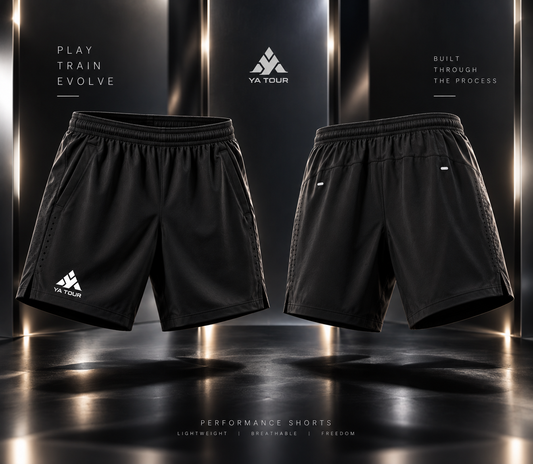 YA TOUR Men's Performance Shorts – Black, front and back product display showing elastic waistband, side pockets, side vent hem and YA TOUR logo on left leg in dark gold-lit studio setting