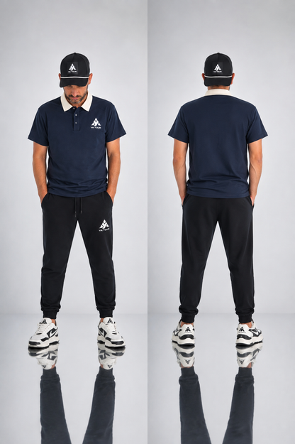 YA TOUR Contrast Collar Raglan Polo Shirt – Navy with Cream contrast collar, on-model front and back editorial view styled with YA TOUR black joggers and black cap, showing raglan sleeves, YA TOUR logo on chest and clean back silhouette