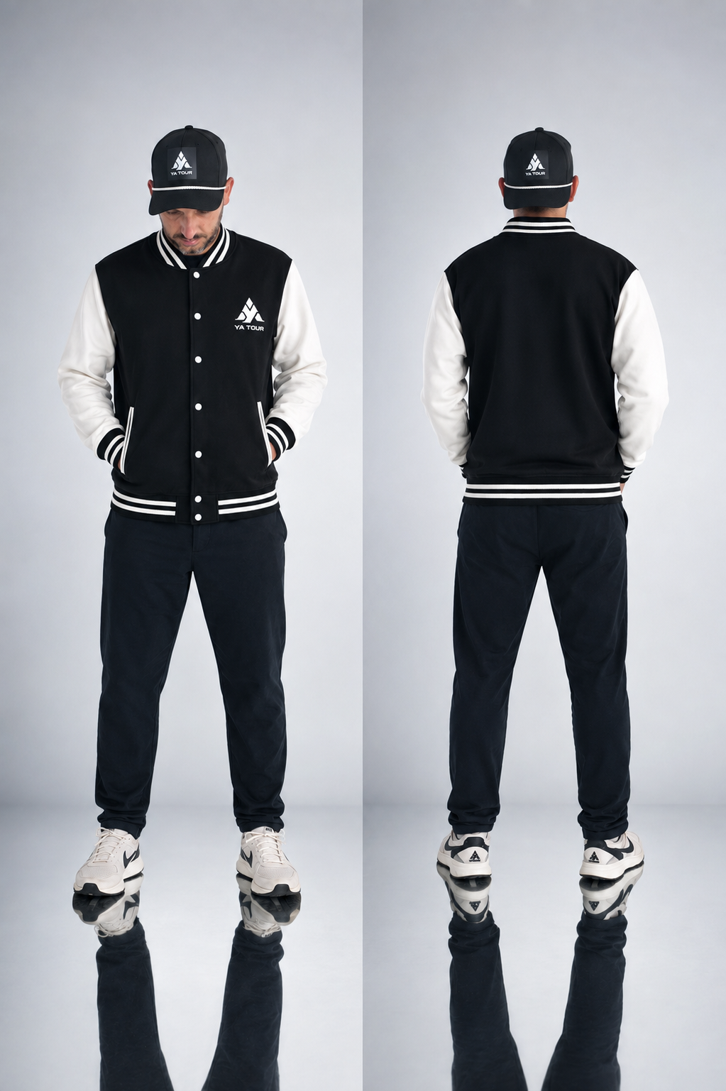 YA TOUR Two-Tone Fleeced Varsity Jacket – Black with White sleeves, on-model front and back editorial view showing snap button closure, ribbed collar, cuffs and hem, YA TOUR logo on chest, styled with YA TOUR black joggers and black cap