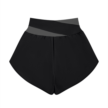 YA TOUR Women's Tennis Panelled Shorts – Black with Dark Gray crossover color block waistband, back flat lay showing high-waist design and curved overlay hem