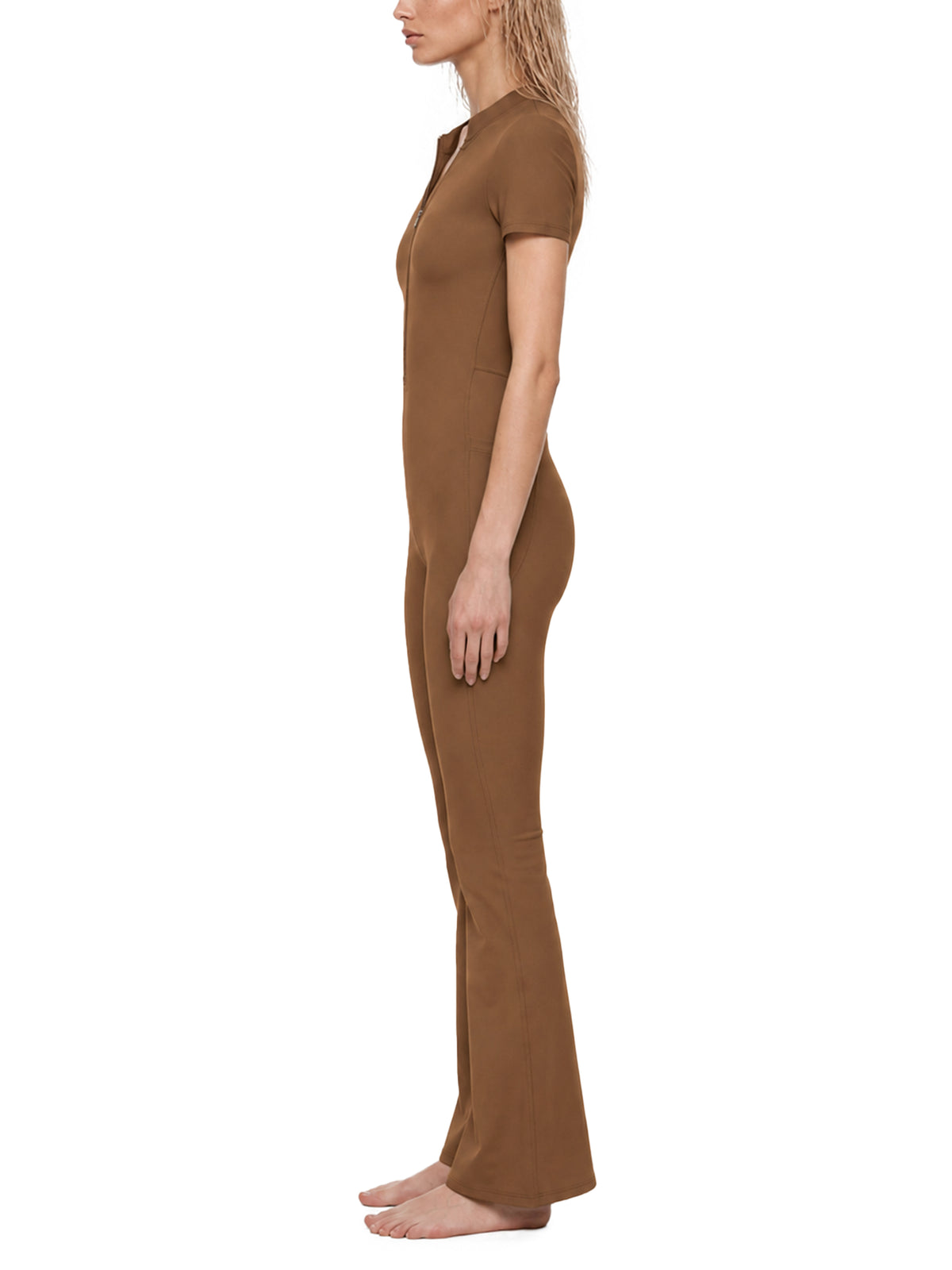 YA TOUR Women's Tight Flared Leg Quarter-Zip Jumpsuit – Brown, on-model side view showing quarter-zip neckline and flared leg silhouette