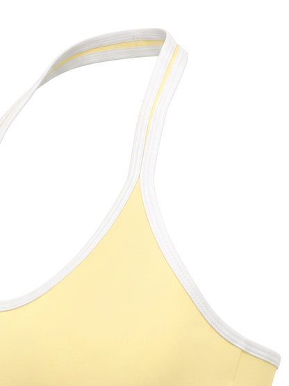 YA TOUR Women's Halter Color Block Sports Bra – Light Yellow, close-up of halter strap crossover and color block edge detail