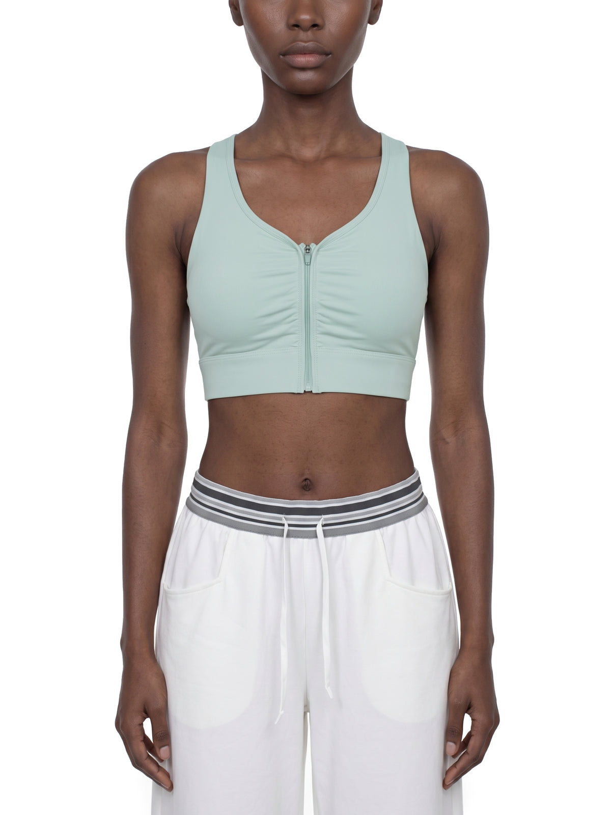 YA TOUR Women's Cropped Zip Sports Bra — on-model front view showing zip closure and cropped athletic fit