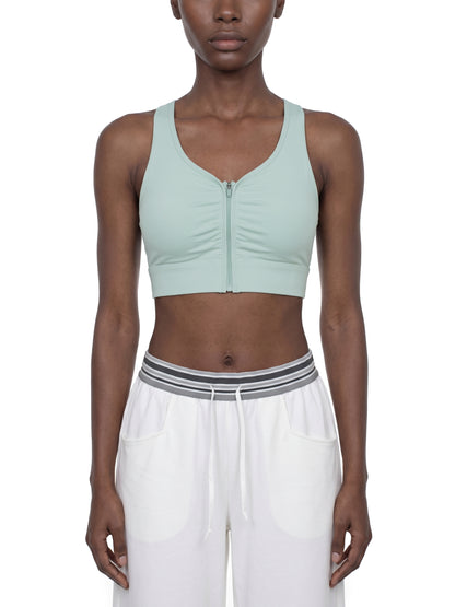 YA TOUR Women's Cropped Zip Sports Bra — on-model front view showing zip closure and cropped athletic fit