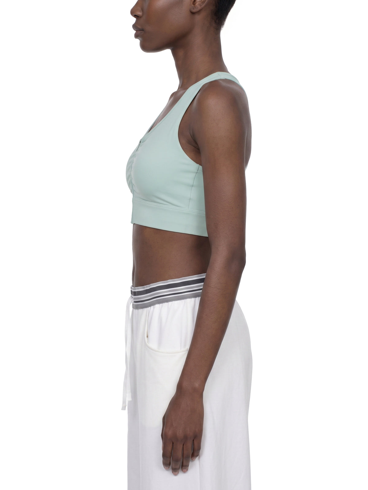 YA TOUR Women's Cropped Zip Sports Bra — on-model side profile showing racerback strap and athletic silhouette