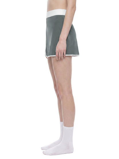 YA TOUR Women's Color Block A-Line Skort dark gray and white — on-model side view showing A-line flare and waistband detail