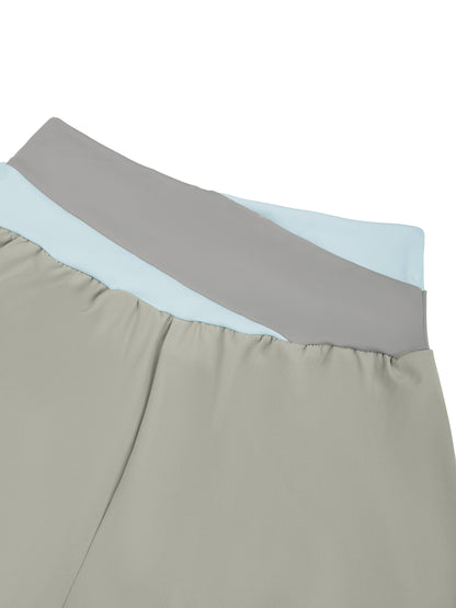 YA TOUR Women's Tennis Panelled Shorts – Light Gray with Light Blue, close-up of crossover color block waistband showing panel construction and high-waist fit