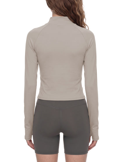 YA TOUR Women's Paneled Tennis Jacket – Apricot with Khaki, on-model back view showing diagonal panel hem detail and thumb hole cuffs