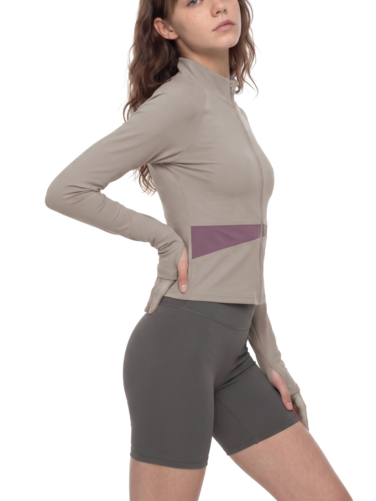 YA TOUR Women's Paneled Tennis Jacket – Apricot with Khaki, on-model side view showing fitted crop silhouette and diagonal panel construction