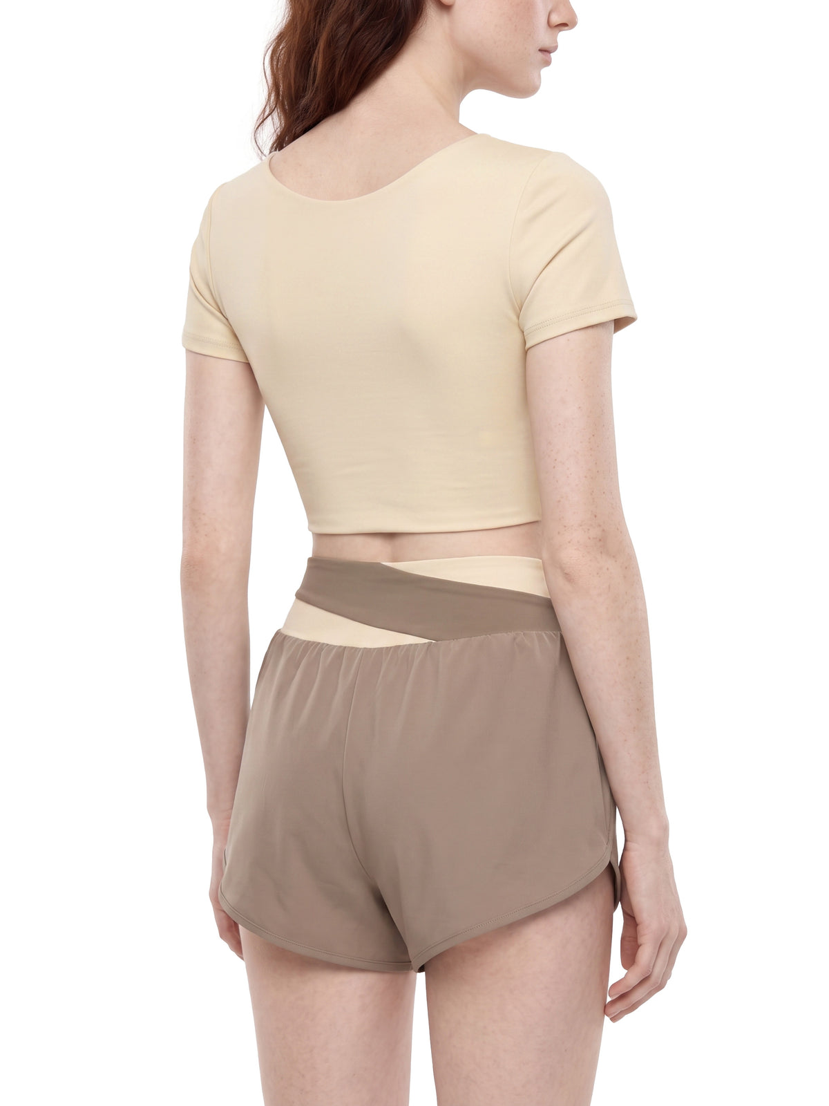 YA TOUR Women's Panelled Crop Tennis T-Shirt – Apricot with Khaki, on-model back view showing U-back neckline, crop length and fabric drape