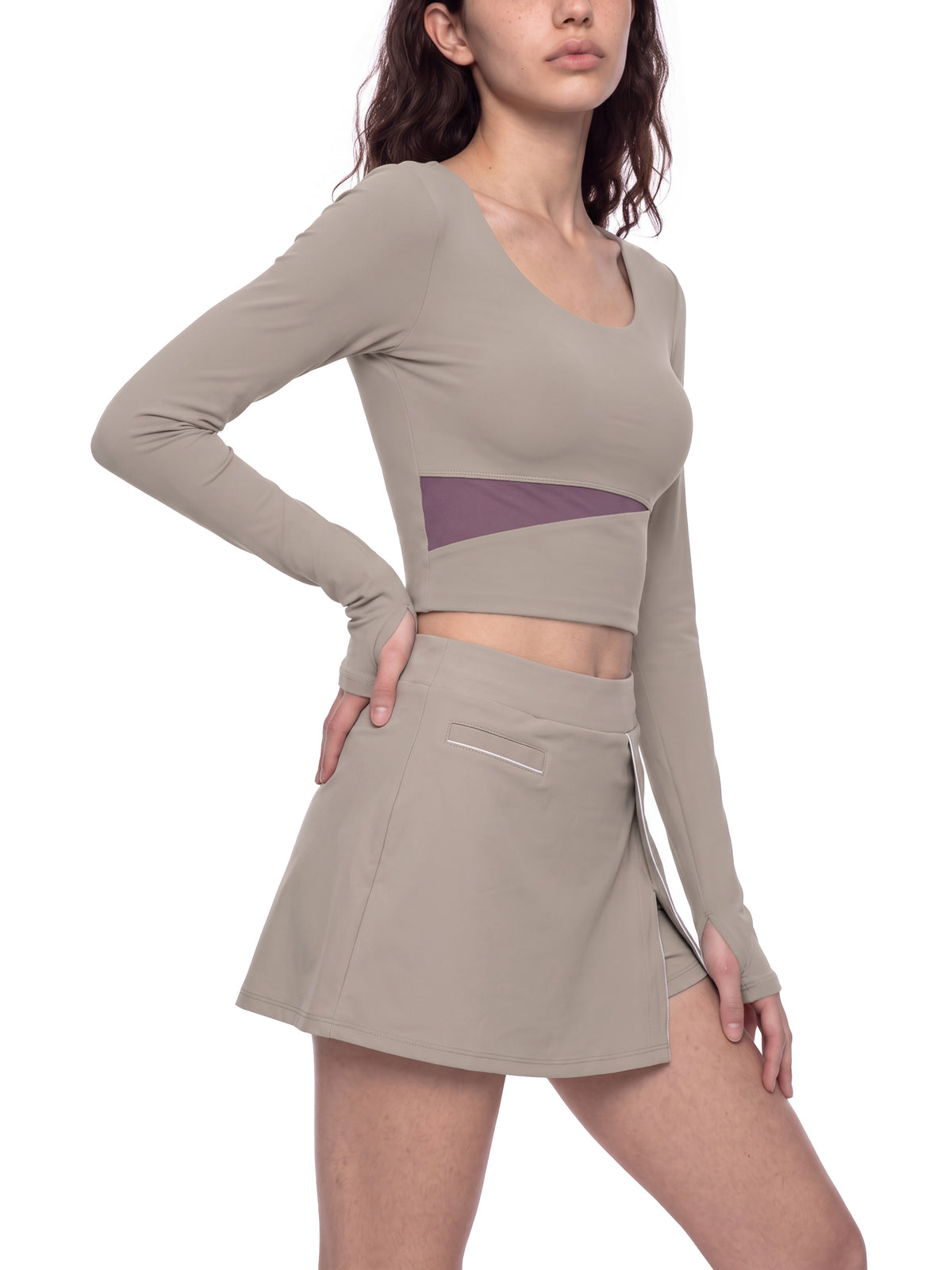 YA TOUR Women's Panelled Long Sleeve Tennis T-Shirt – Apricot with Khaki, on-model front view showing diagonal panel detail and fitted crop length